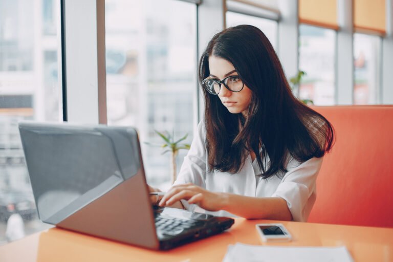Woman working on a laptop in a modern office