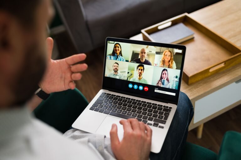 Team members collaborating in a virtual meeting on a laptop